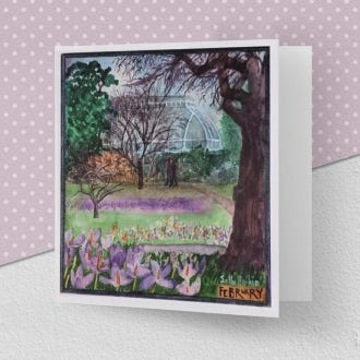 Image of the greeting card illustrating the month of February, with lilac crocuses on the foreground and part of the palm house in the background.