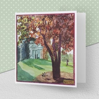 image of the greeting card illustrating the month of November at Kew Gardens, featuring the temple of Bellona in the background and a large tree with auburn leaves in the foreground .