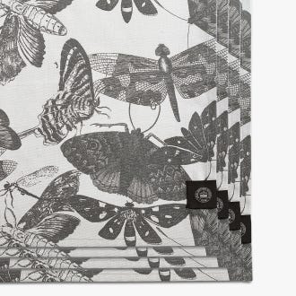Set of four napkins inspired by the stunning and intricate artwork found in the extensive Royal Botanic Gardens, Kew. Light grey napkins with darker grey artwork of insects including butterflies and dragonflies. Kew logo featured in bottom right.
