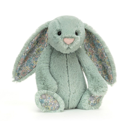 Sage fluffy green bunny with big floppy ears featuring a blossom pattern. Blossom pattern also featured on bottom of feet. Bead eyes and sweet pink nose. White fluffy pom pom tale.
