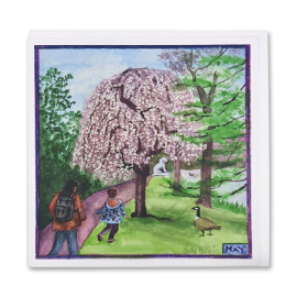 image of the greeting card illustrating the month of May at Kew Gardens, with a tree covered in pale pink blooms in the foreground.