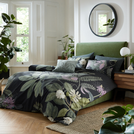 Dramatic and bold, with huge leaves and stunning flowers, this bed set puts plants at the fore. Charcole bedding with big leaves and pink and pale yellow flowers.  The statement continues with a reverse print in a tonal pin stripe of charcoal and green gr