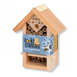 Image of the insect house on profile made in wood on a white background. The packaging reads: Nooks & Crannies, make a little extra space for insects.