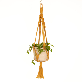 Image of the knotted hanger in mustard colour with a potted tradescantia hanging from it.