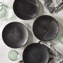 Set of four black plates in the Kew Living Jewels range. Each plate has a different design of a winged insect.