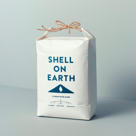 Shell on Earth recyclable bag filled with crushed whelk shells and tied with a bow.