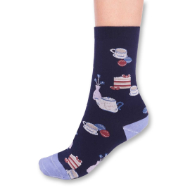 Side view of one sock featuring an afternoon tea pattern, complete with macarons, cakes and mugs on a navy colour base and light blue heel and toe.