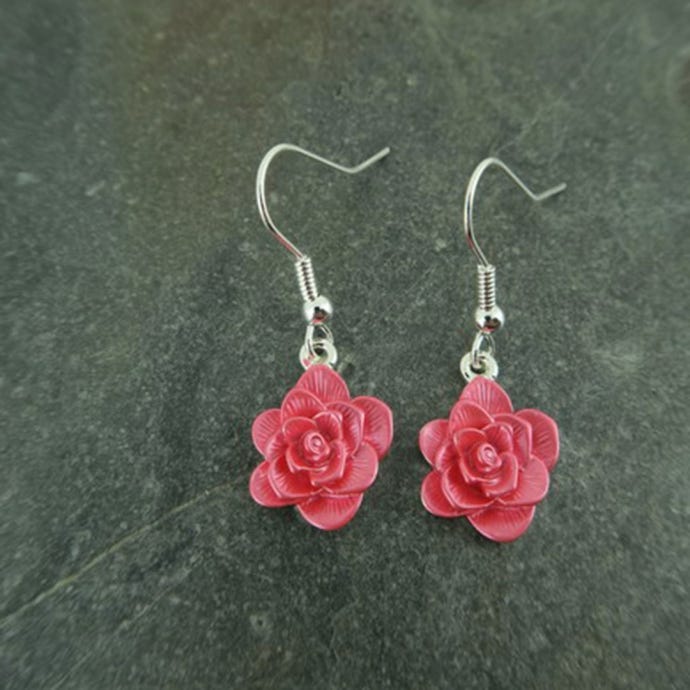 Pink Alexander Thurlow hanging Camellia earrings.