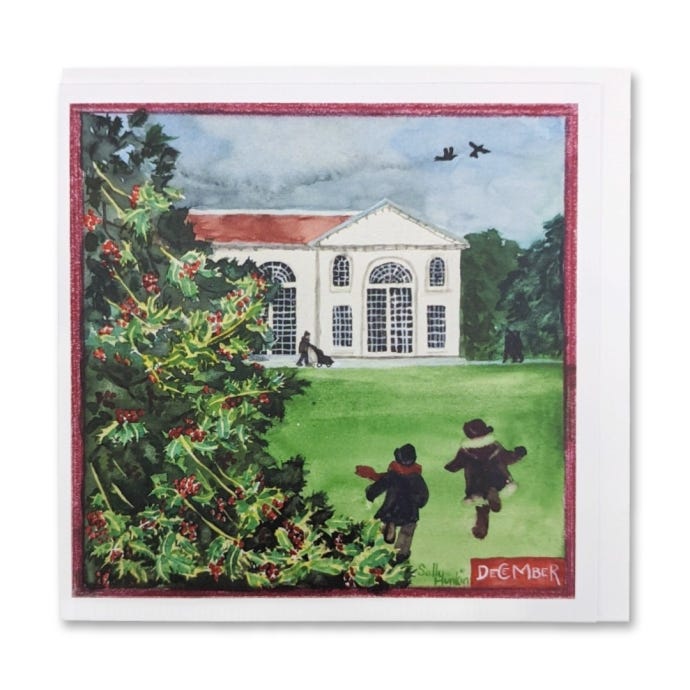 image of the greeting card illustrating the month of December at Kew Gardens, featuring and a holly tree in the foreground with two children running towards the Orangerie illustrated in the background.