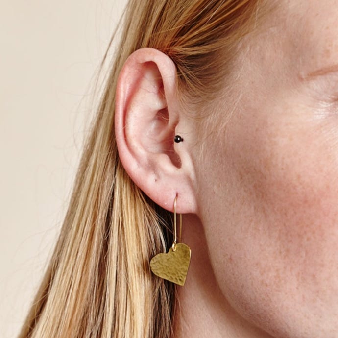 Hammered Heart Drop Earrings in gold from Just Trade, lifestyle image