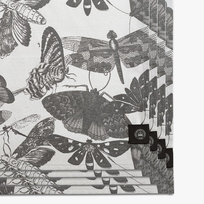Set of four napkins inspired by the stunning and intricate artwork found in the extensive Royal Botanic Gardens, Kew. Light grey napkins with darker grey artwork of insects including butterflies and dragonflies. Kew logo featured in bottom right.