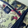 Close up of Kew Fruit and Floral Double Oven Glove with pale green background and deep blue lining and inner.