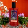 Red Eau de Toilette bottle with red background, surrounded by flowers.