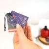 Hand holding the lavender and Rosemary Eau de Toilette labels
