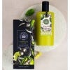 Green bottle of the Lemongrass and Lime Eau de Toilette with label and black lid. Packaging contains botanical illustration.