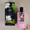Pink bottle of the Magnolia and Pear Eau de Toilette with label and black lid. Packaging contains botanical illustration.