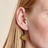 Hammered Heart Drop Earrings in gold from Just Trade, lifestyle image