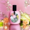 Magnolia and Pear Body Oil with magnolia flowers and a pear in the background
