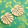 Lifestyle image of Hammered Tropical Leaf Drop Earrings by Just Trade