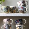 Display of the new Kew mugs collated on two shelves. 