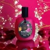 Osmanthus Rose Body Oil surrounded by red roses