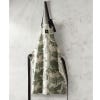Lifestyle image of beautiful apron made in 100% cotton hanging from peg, inspired by the stunning and intricate artwork found in the extensive Royal Botanic Gardens, Kew's archives. Apron has black straps with an adjustable neck strap. Artwork contains il