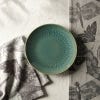 Salad plate on complimenting napkins and tea towels from the range. Positioned on white surface.