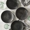 Set of four black plates in the Kew Living Jewels range. Each plate has a different design of a winged insect.