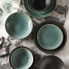 Lifestyle image of beautiful table runner inspired by the stunning and intricate artwork found in the extensive Royal Botanic Gardens, Kew's archives. Light grey tea towel featuring dark grey artwork of insects. Bowls, plates and cutlery pictured.