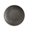 One of the black plates in the set of four depicting a close up design of a winged insect.