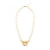 The necklace features an oversized bee with rich 18ct gold plate, hues of yellow enamel fill the intricate wings. Set on a stand of simulated cream pearls