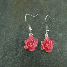 Pink Alexander Thurlow hanging Camellia earrings.